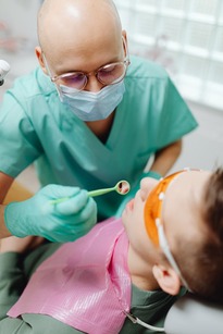 child dentist child being examined by a pediatric dentist