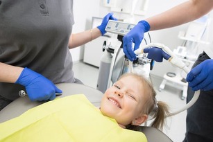 kids dentist child in a pediatric dentist's chair